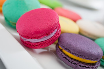 colorful magaroon is placed in a white ceramic dish. Elegant marble dining table with coffee table.