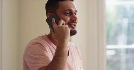 4K Smiling confident man talking on cell phone indoors. Slow motion. - Powered by Adobe