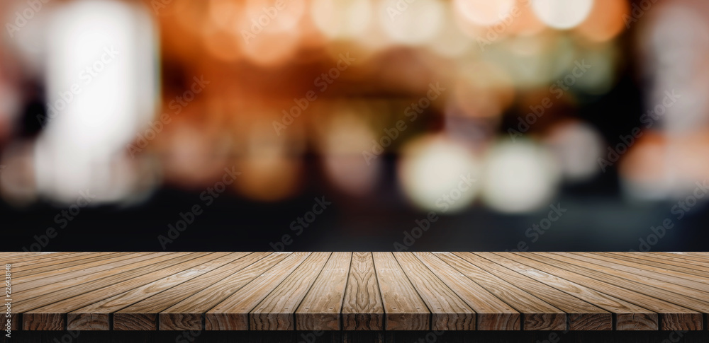 Aufkleber Plank Wood table top with blur nightclub bar counter with bokeh light background,banner mock up for display of product or design content.