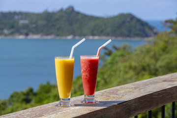 Two fresh organic shake from mango and watermelon in thai restaurant on the beach near sea in Thailand