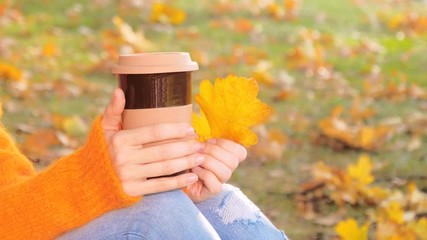 Female hands with coffee cup and autumn leaves, drinking hot coffee - Powered by Adobe