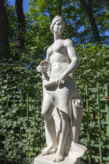 Fototapeta na wymiar Statue from the collection of marble sculptures by Italian masters of the late XVII - early XVIII centuries in the Summer Garden in St. Petersburg
