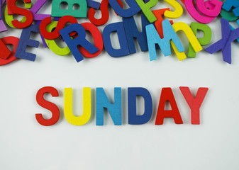 Colorful wooden alphabet with text sunday