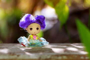 The doll in the garden and beautiful nature.