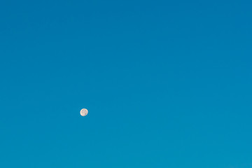 Moon in the morning blue sky