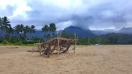 Shaded beach hut on shoreline. - 226440934