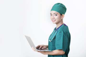 Healthcare concept, woman doctor working with laptop and stethoscope isolated on white background.