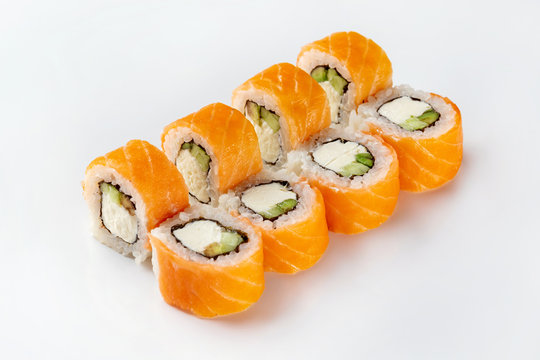 Closeup image of classic philadelphia sushi rolls with salmon, cheese and cucumber isolated at white background.