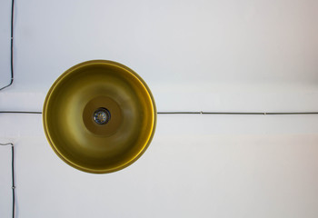 a gold chandelier against a white ceiling