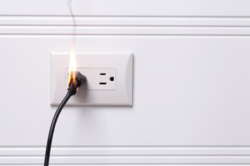 Overheated electric plug got on fire - obrazy, fototapety, plakaty