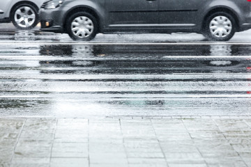 car reflecting in wet asphalt road during rainy weather. car traffic in motion