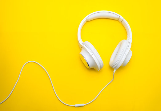 White headphones on yellow background