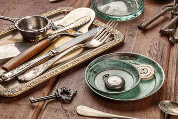 A photo of many vintage objects, flea market stuff on a wooden background