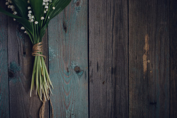 Lily of the Valley on old wooden background