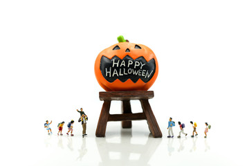 Miniature people : children with Halloween characters decorations using for concept of party...