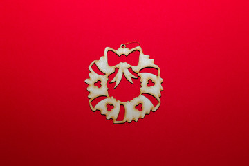 Christmas wooden toy christmas wreath on a red background