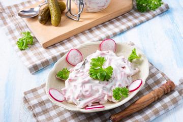 delicious homemade meat salad with mayonnaise and cucumber