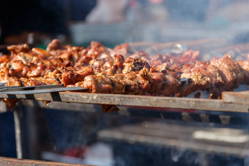 Grilled kebab cooking on metal skewer. Roasted meat cooked at barbecue