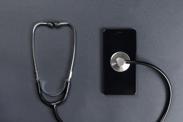 Fototapeta na wymiar Smartphone and stethoscope concept of repair or treatment