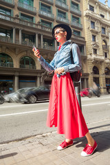 Tourism in Europe, woman tourist with smartphone on the street of Barcelona 