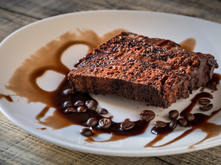 Slice of cake with cream coffee and coffee beans