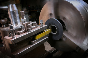Metal worker working on lathe