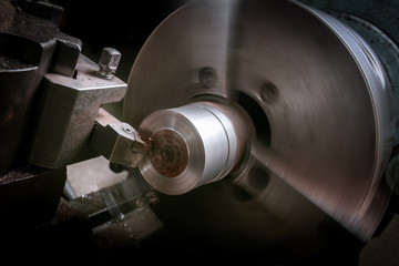 Metal worker working on lathe