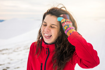 Happy woman on a on snow covered mountain