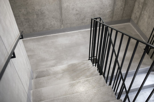 Modern elegant minimalist concrete staircase with black steel railings, Escape concrete stairs