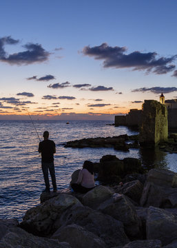 Fisherman staring by the port in the old city, Acre (Akko), Israel.
