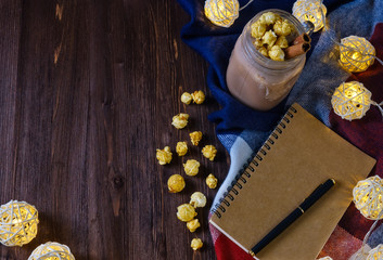 cocoa with popcorn and cinnamon on a slate background with lights