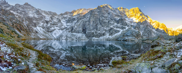 Tatra National Park, a lake in the mountains at the dawn of the sun. Poland - obrazy, fototapety, plakaty