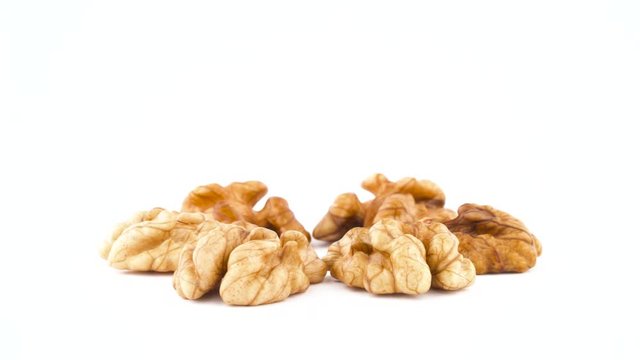 Star shaped walnuts without the shell. Rotating on the turntable isolated on the white background. Close up. Macro.