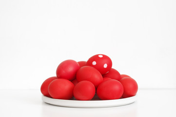 Red Easter eggs in plate