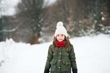 A portrait of a small girl in snow.