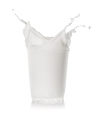 Splash in transparent glass of milk