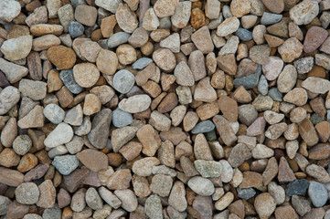 Stone pebbles brown and gray gravel texture background for decoration.