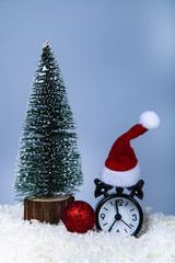 Clock in a Santa hat,Christmas tree and balls