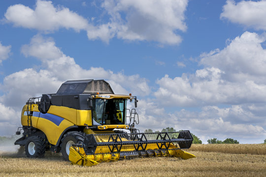 combine-harvester in the field to gather the harvest of grain crops, rye, wheat