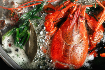 Fototapeta na wymiar Boiled crawfish dill bay leaf boiling water saucepan black background Cooking crayfish