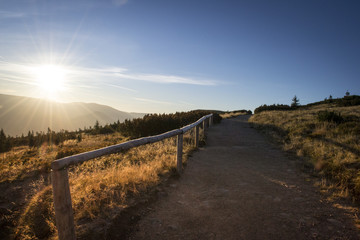 Fototapeta premium Beautiful colorful hiking road path at Krkonoše mountain national park at sunrise at sunset