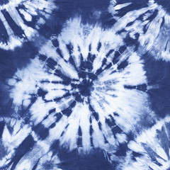 Abstract tie dyed fabric of indigo color on white cotton. Hand painted fabrics. Shibori dyeing