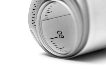 Close-up paper measuring tape roll  isolated on white background with copy space