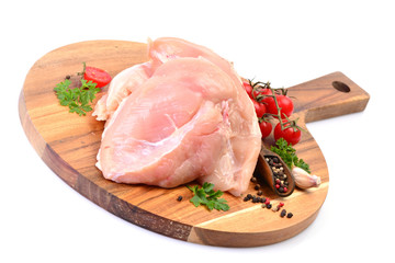 Chicken meat with spices and vegetables on a white background