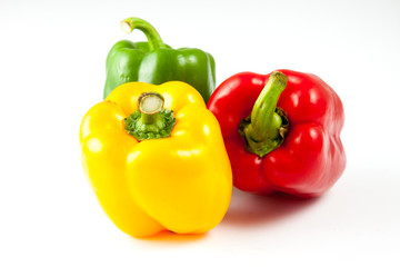 Obraz na płótnie Canvas bell peppers over white background, Green, yellow and red Fresh capsicum pepper