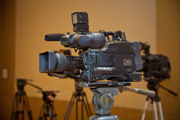 Professional video camera set on a tripod with excellent clipping path . Professional production video camera. video camera in business conference room recording participants