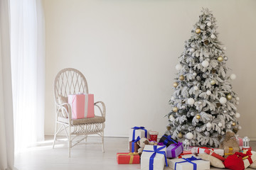 the Interior of the white room with a Christmas tree and Christmas gifts