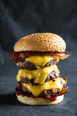 Big cheeseburger on a dark background