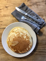 Homemade breakfast pancake stack with cutlery and napkin
