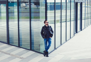 Photo of handsome stylish man in black leather jacket.